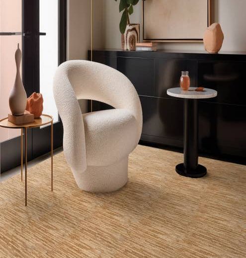 White chair and to small round tables sitting on Ambrose Maple carpet