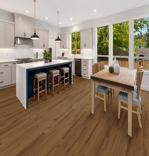 White and blue kitchen and dining room table and chairs over golden brown vinyl plank floors, with large windows overlooking outdoor deck