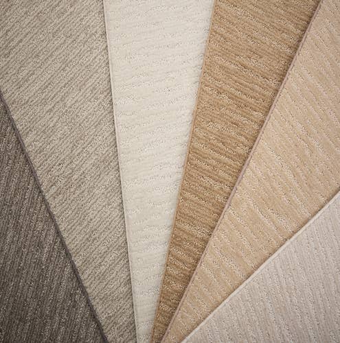 Plush charcoal, gray, cream, and tan carpet with small texture lines