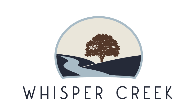 Whisper Creek in black letters, partial circle outlined in blue with a brown tree, light blue road and dark blue hills.