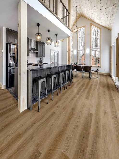 A-frame home interior featuring large windows and modern farmhouse kitchen and dining area, over Hartford Camel LVP flooring