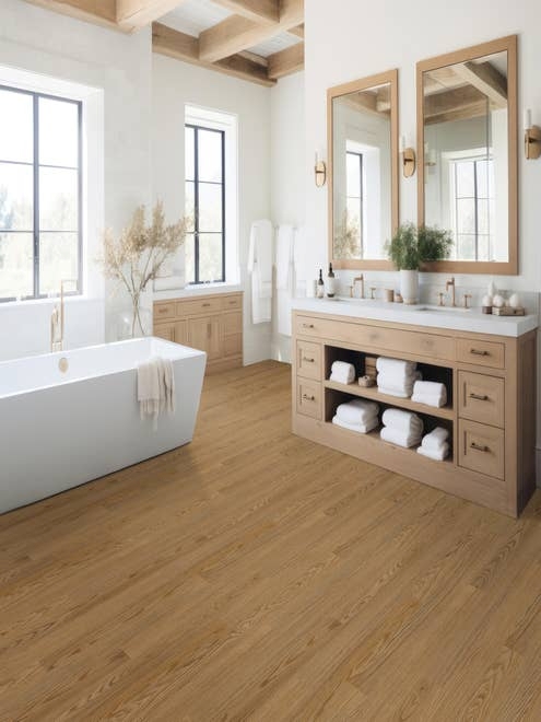 Luxurious bathroom with white walls, exposed wood beams, natural light, free-standing tub, and dual sink organic wooden vanity, over Oakridge Barley LVP