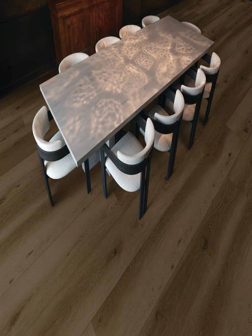Gathering area with table and chairs, over warm, dark wide-plank Park City Grizzly floor