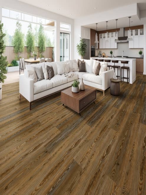 Open-concept living room, kitchen, and patio seating area furnished with contemporary pieces and a wide brown plank floor