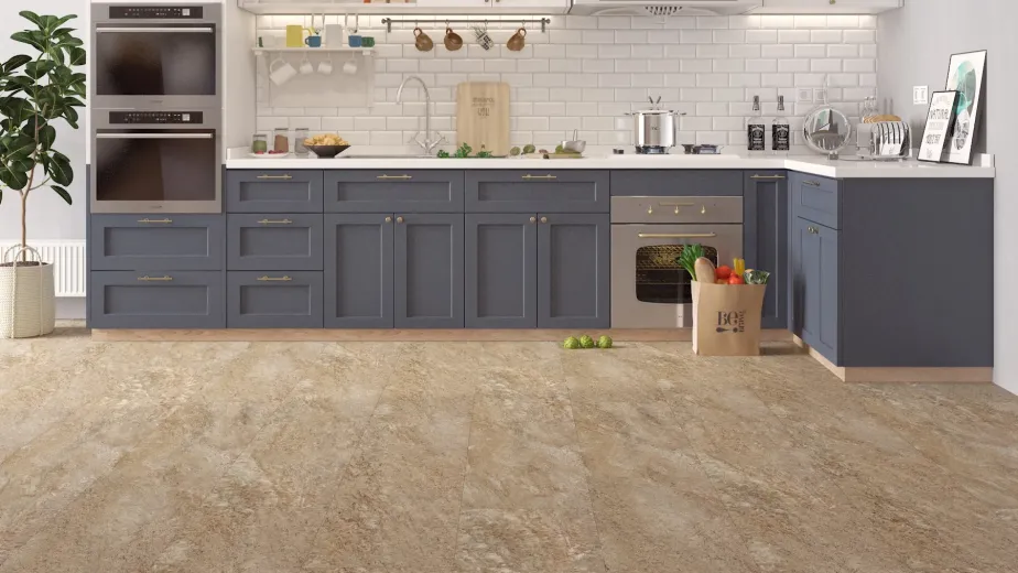 Blue and white kitchen with bag of groceries on beige, gray, and cream speckled stone luxury vinyl tile