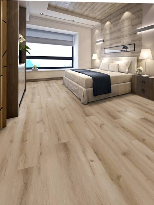 Bedroom with large black framed window, built-in dresser, light brown wood-look floor, and linear patterned wall behind bed