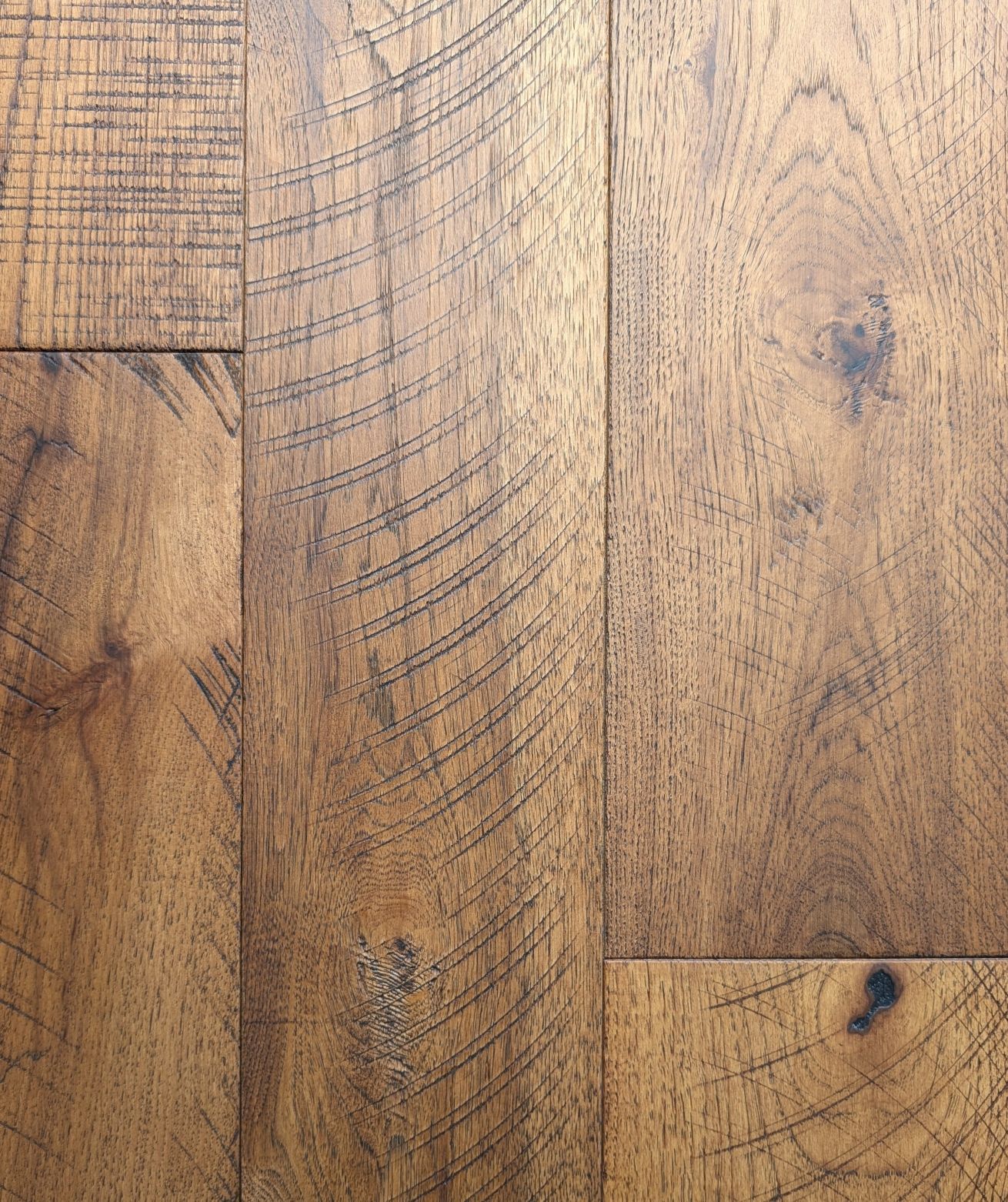 Dark brown hardwood flooring with sawmark characteristics