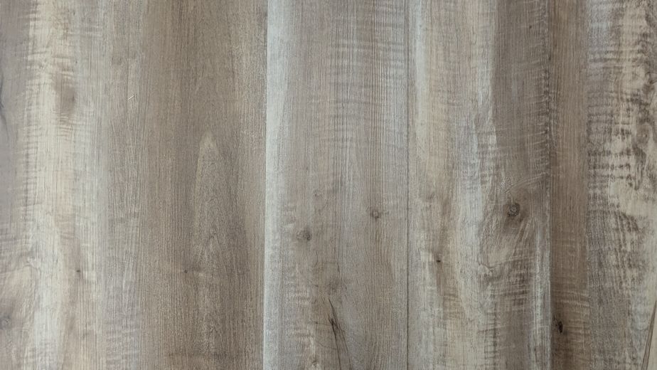 Tavern Oak luxury vinyl plank sample showing grays and taupes for a rustic, slightly weathered wood look
