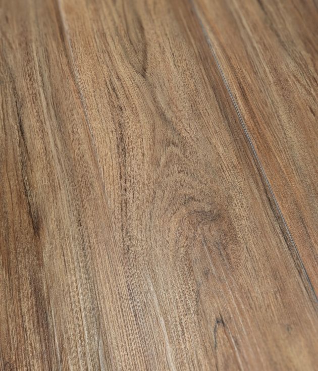 Sample of Teak Marado, a warm brown luxury vinyl plank with wood knots and grains