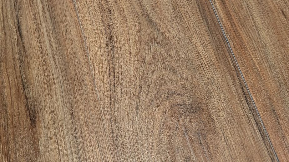 Sample of Teak Marado, a warm brown luxury vinyl plank with wood knots and grains