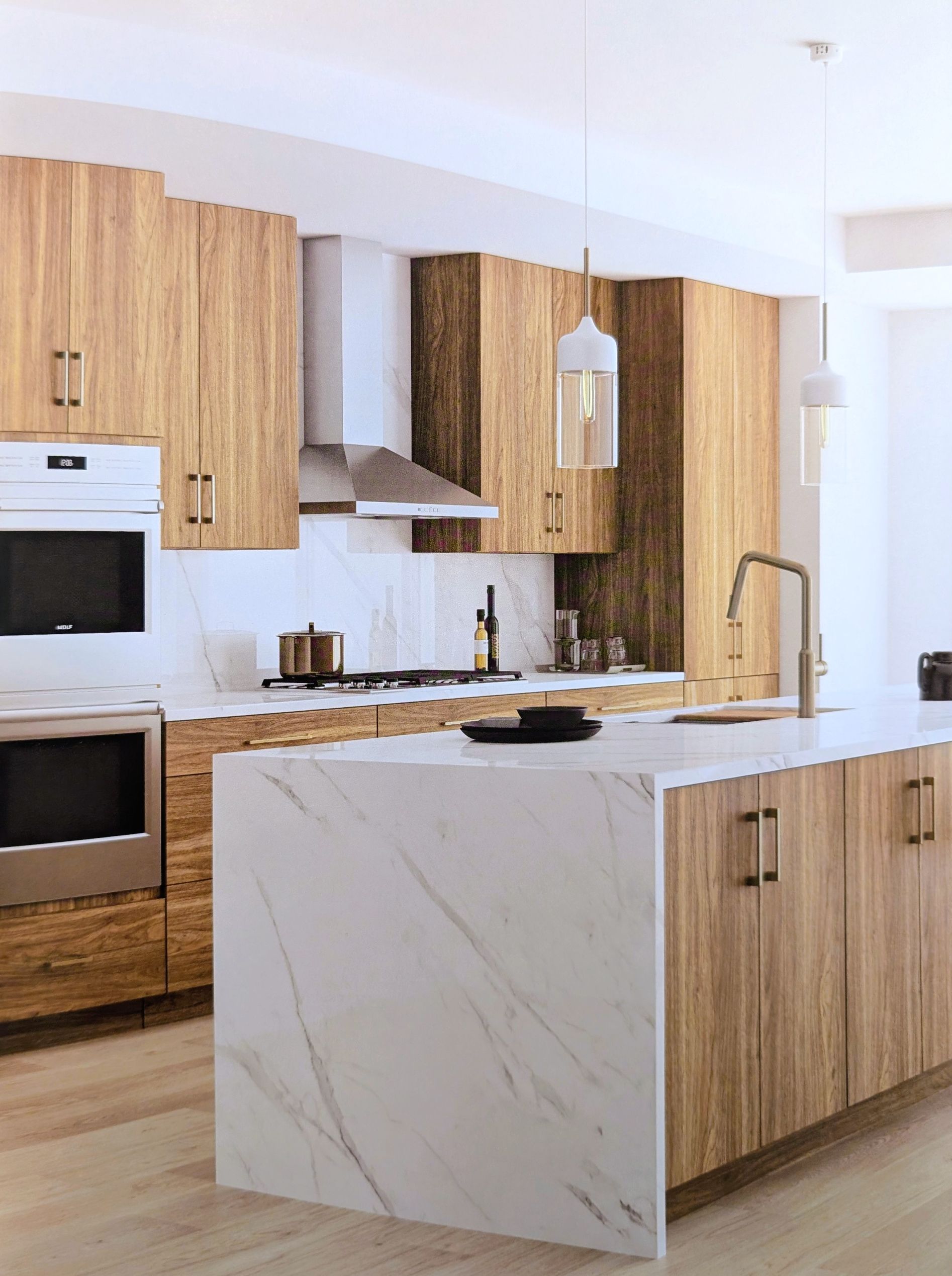 Hallmark wood cabinets in bright kitchen with white marble island