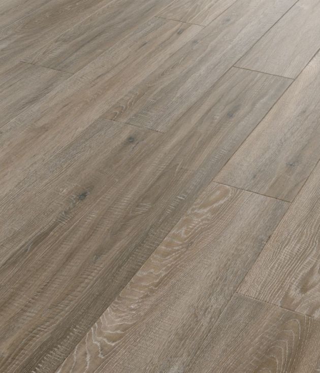 Sample of Tweed Oak, a luxury vinyl plank blending mid brown, blue, and gray tones with subtle knots and woodgrain texture